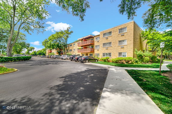 Front view of a three-story apartment building with balconies.