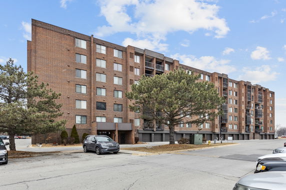 Front view of a multi-story brick apartment building.