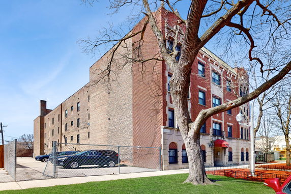 Front view of a multi-story brick apartment building.