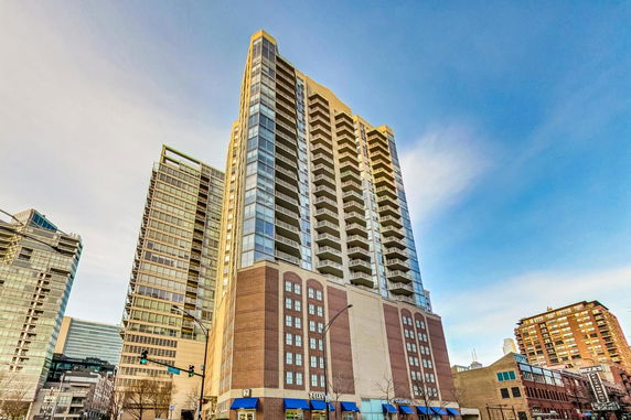 Front view of a tall apartment building in an urban setting.