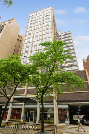 Front view of a tall multi-story building with large windows.