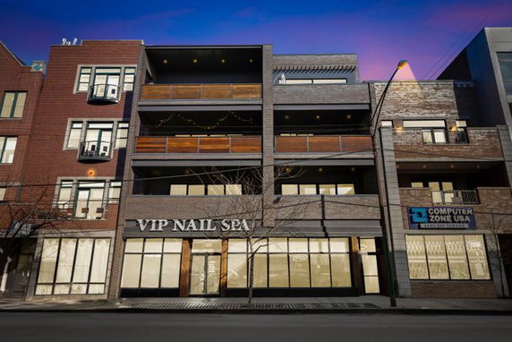Front view of a multi-story commercial building with balconies.