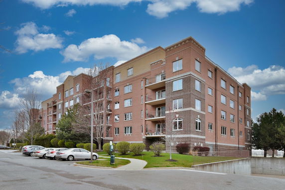 Front view of a multi-story brick apartment building.