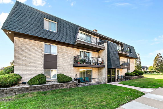 Front view of a multi-story residential building with balconies.