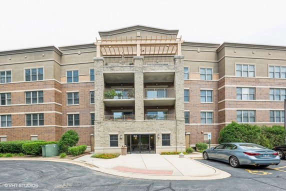 Front view of a multi-story residential building with balconies.