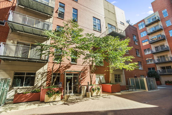 Front view of a multi-story apartment building with balconies.