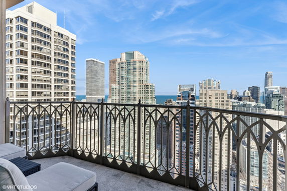 Panoramic view of city skyline from a high-rise balcony.