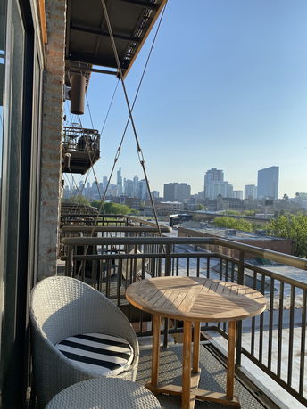 View of surrounding areas from a balcony with city skyline in the background.