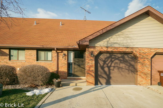Front view of a house with brick exterior and attached garage.