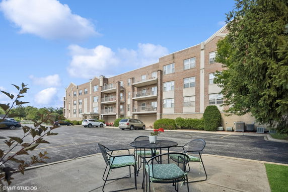 Front view of a multi-story residential building with balconies.