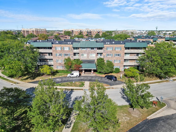Front view of a multi-story apartment building with balconies.