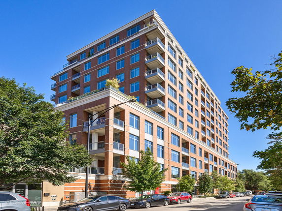 Front view of a multi-story residential building with balconies.
