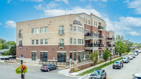Front view of a multi-story building with a mix of brick and stone facade.