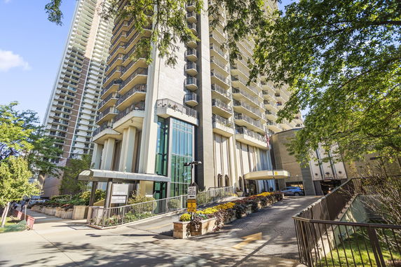 Front view of a multi-story building with multiple balconies.