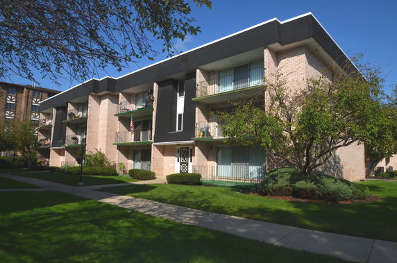 Front view of a multi-story residential building with balconies.