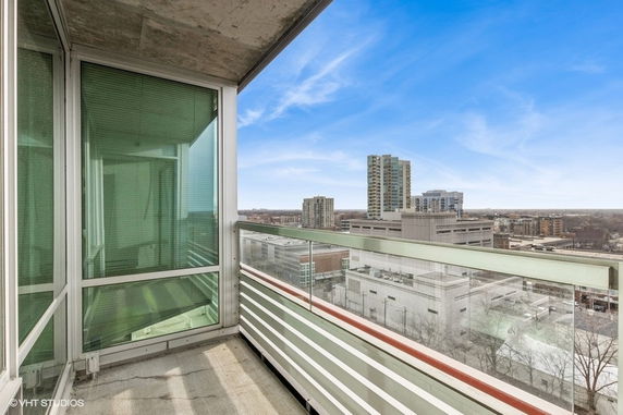 Panoramic view from a balcony with surrounding buildings in the background.