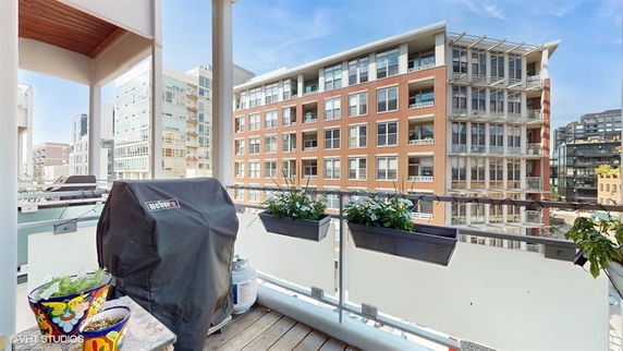 Panoramic view from a balcony overlooking nearby apartment buildings.