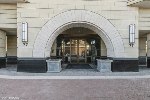 Front view of a building entrance with an arched design.