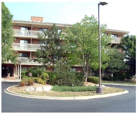 Front view of a multi-story building with balconies.