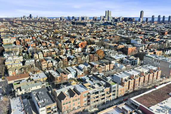 Panoramic view of a cityscape with numerous residential and commercial buildings.
