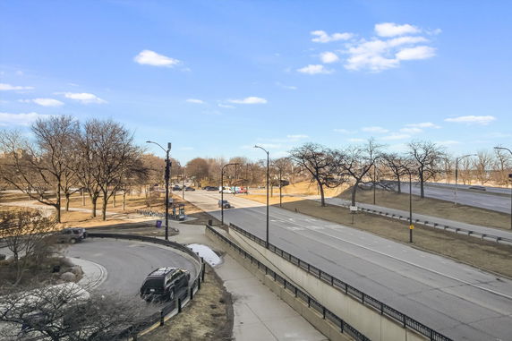 Wide angle view of roads and surrounding area with trees.