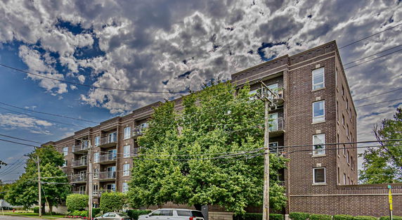 Front view of a multi-story brick apartment building.