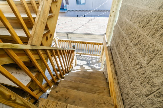 Staircase leading down from a building's outdoor area.