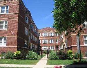 Front view of a multi-story brick apartment building.