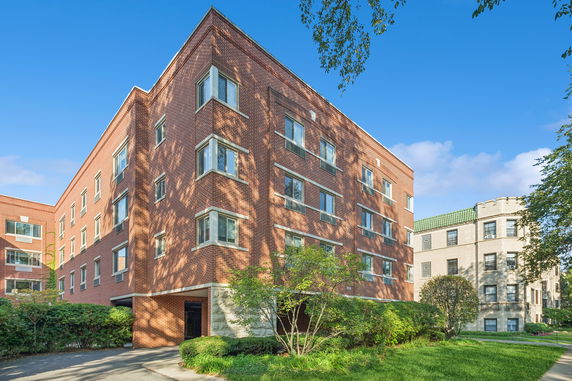 Front view of a multi-story brick apartment building.