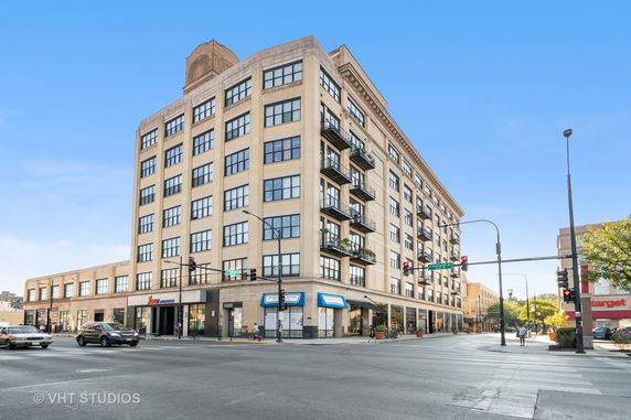 Front view of a multi-story building on a corner street.
