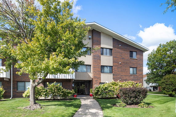 Front view of a multi-story brick apartment building.