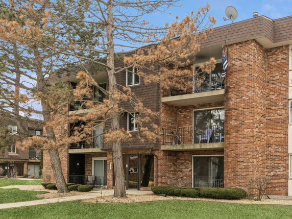Front view of a multi-story brick apartment building.
