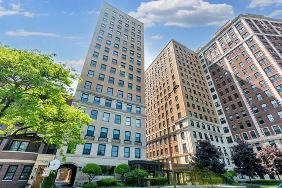 Front view of three tall residential buildings with multiple windows.