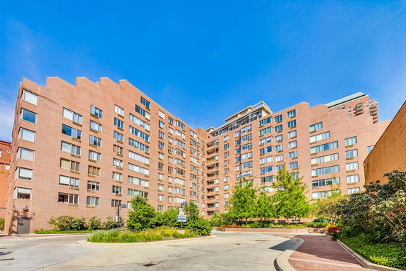 Front view of a multi-story brick apartment building.
