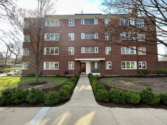 Front view of a four-story brick apartment building