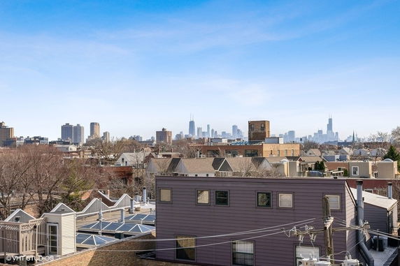 Panoramic view of a city skyline with residential buildings in the foreground.