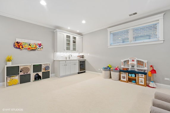 Indoor play area with toys and a play kitchen set.