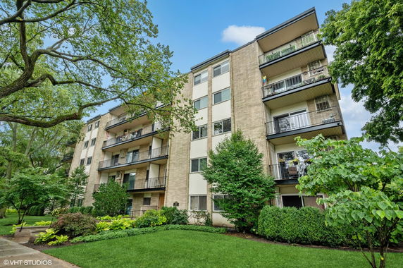 Front view of a multi-story apartment building with balconies.