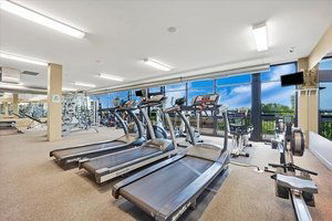 Interior of a fitness gym with treadmills and exercise equipment.