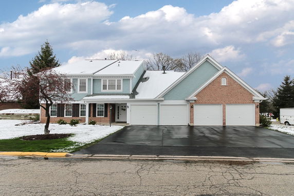 Front view of a two-story house with a triple garage.