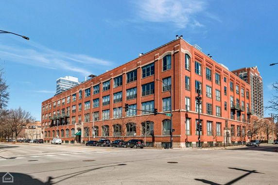 Front view of a multi-story brick building on a street corner