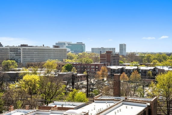Panoramic view of urban area with various buildings and greenery.