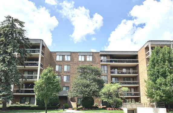 Front view of a multi-story residential building with balconies.