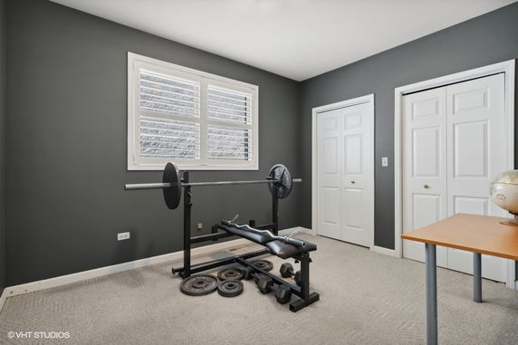 Room with gym equipment and a window.