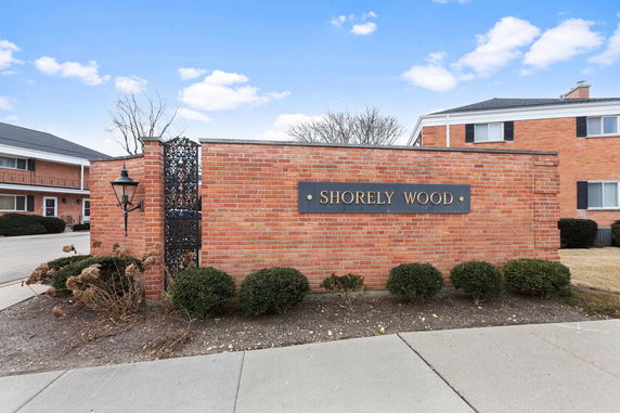 Front view of a brick building complex with a sign reading 'Shorely Wood.'