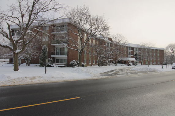 Front view of a multi-story brick building during winter.