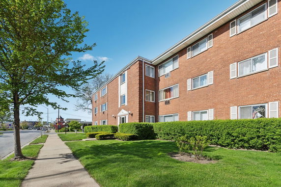 Front view of a three-story brick apartment building.