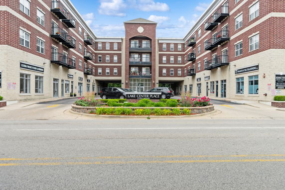 Front view of a multi-story commercial building with brick facade and multiple balconies.