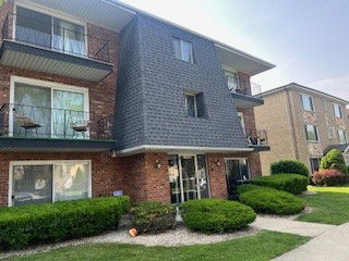 Front view of a multi-story residential building with balconies.