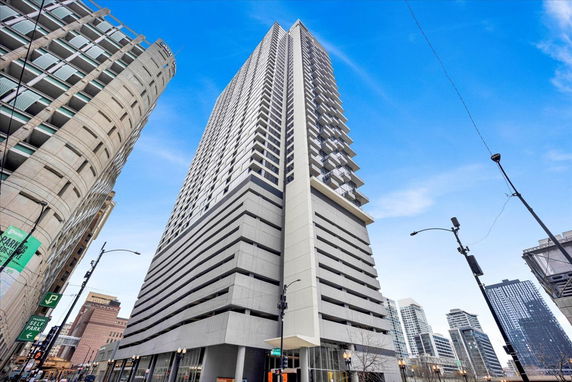 Front view of a tall multi-story building with balconies.